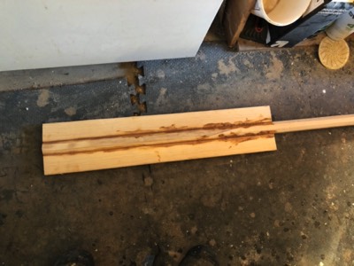  2/24/18 - pieces of spruce are epoxied to either side of the shaped oar shaft. 