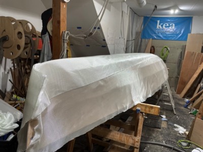  Fiberglass cloth is laid on the hull.  