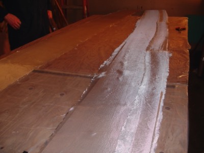  1/28/11 - Fiberglass cloth is laid out onto the number 3 panels. 
