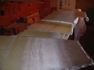  Fiberglass cloth is laid out on the foward sole, console parts, and driver's seat parts.   