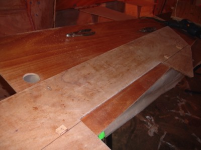  3/18/11 - Blocks are hot glued on bulkhead #5 to act as guides for deck cleats.  